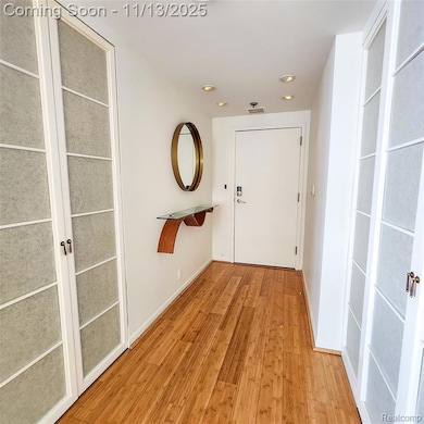Hallway featuring light wood-type flooring and recessed lighting