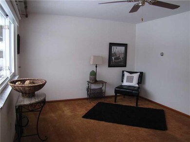 Living Room. The living room has a ceiling fan for