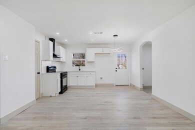 Kitchen with visible vents, arched walkways, light