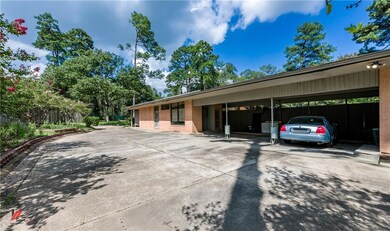 Three car carport and drive with extra parking.