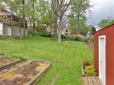 THE BACK YARD IS EQUIPPED WITH A STORAGE SHED, HER