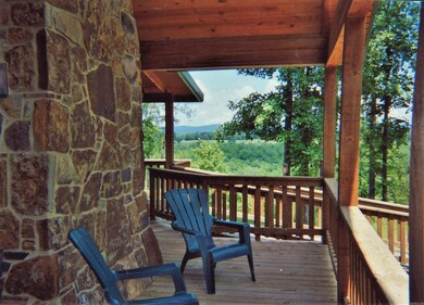 Front porch with rock chimney and view