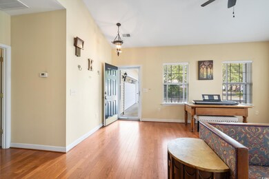 Entryway with ceiling fan, plenty of natural light