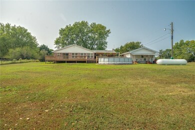 Exterior back view of home and spacious lot