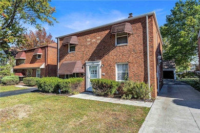 View of front of house featuring brick siding and a front lawn