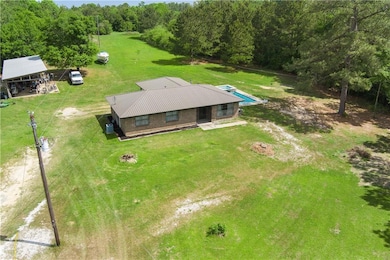 Birds eye view of property with a wooded view