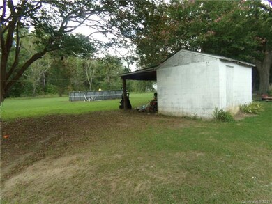 Spacious back yard with storage and above ground p