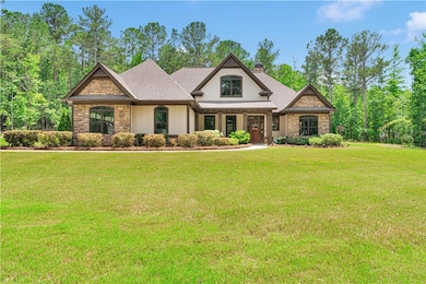 Craftsman-style house featuring stone siding, a chimney, and a front lawn