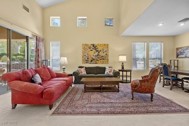 Living room featuring high vaulted ceiling