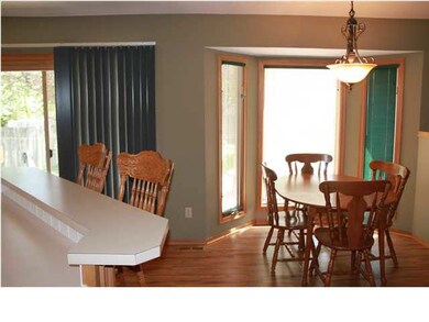 Dining with bay windows overlooking gorgeous backy