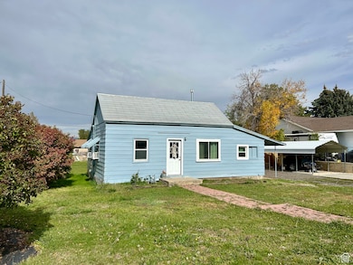 View of front of property featuring a detached carport