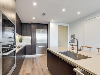 Kitchen featuring stainless steel appliances, lig