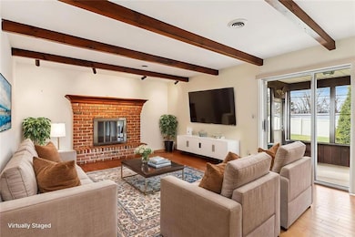 Family Room with wood burning fireplace and beamed