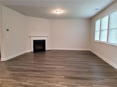 Unfurnished living room with baseboards, a firepla