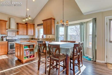 Kitchen featuring dark wood-type flooring, wall ch