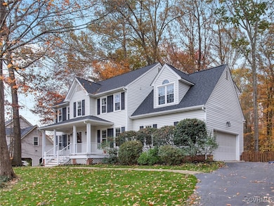View of front facade featuring a porch, a garage,