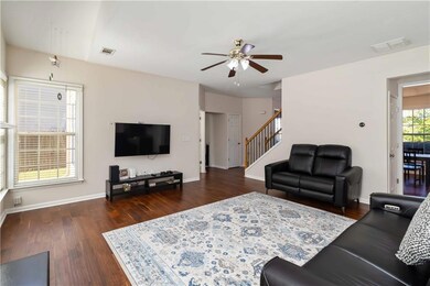 Living room featuring a ceiling fan, wood finished