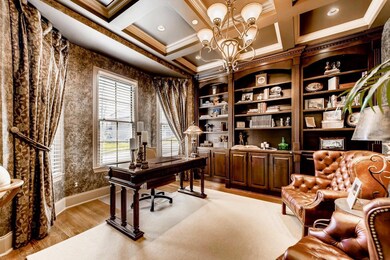 This well-appointed study creates an elegant first impression as you first walk in to the home. Coffered ceilings, built-ins showcase this magnificent space.