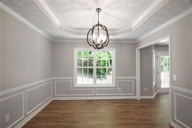 View of the dining room with a view of the private backyard.