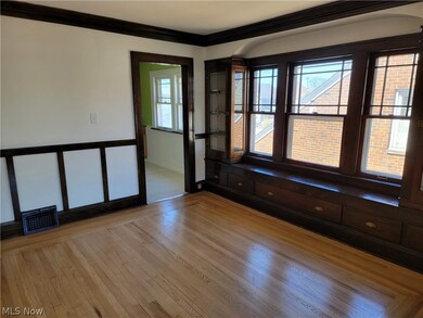 Empty room with ornamental molding and light hardwood / wood-style flooring