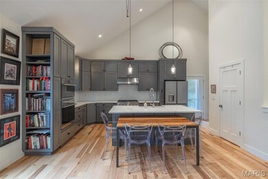 Chefs designed kitchen with custom cabinetry, solid surface counters, walk in pantry