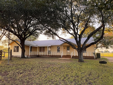 View of front of property featuring a metal roof 
