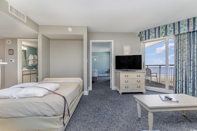 Carpeted bedroom featuring a textured ceiling, acc
