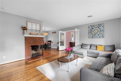 Living room with a brick fireplace and hardwood /