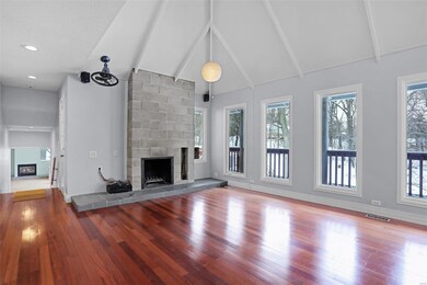 Wood burning fireplace, wood floors and cathedral ceilings with exposed beams.