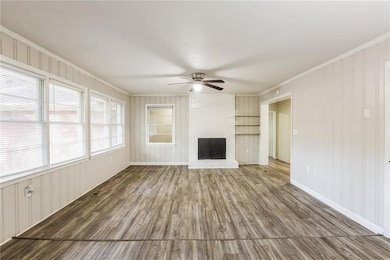 Unfurnished living room featuring ceiling fan, a b