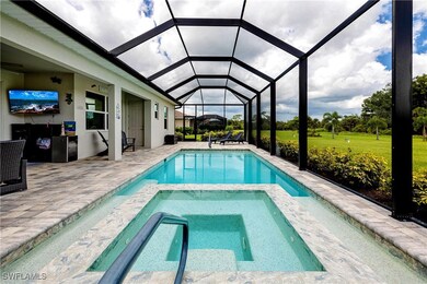 View of pool with a lanai, an in ground hot tub, a