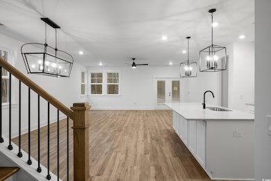 Kitchen with recessed lighting, light wood-style f