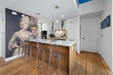 Kitchen featuring a sink, light countertops, buil