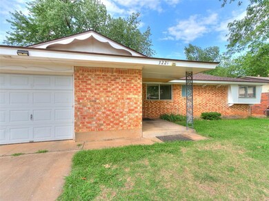 Ranch-style home featuring a garage and a front ya