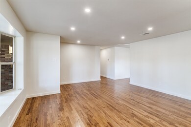 Living room with view of entry and hallway to bedroom areas.