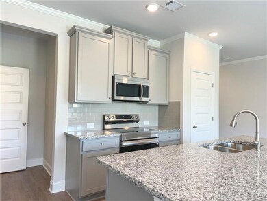 Kitchen featuring gray cabinets, a sink, and stain