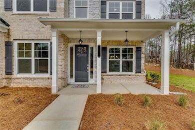 Property entrance featuring brick siding and cover