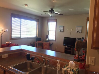 Living room is good sized, with lots of windows on