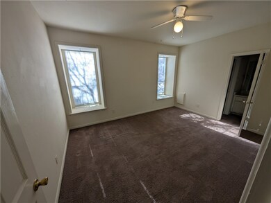 Empty room featuring ceiling fan and dark colored