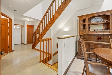 Main entry showing stairways up and down and dining area open floor plan