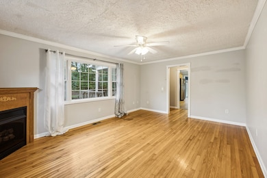 Another view of your living room with ceiling fan & hardwood flooring. 401 McClure St. Red Boiling Springs, TN 37150