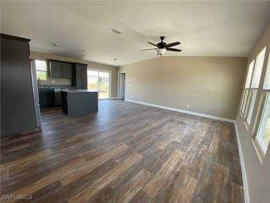 Unfurnished living room with dark wood-style floor