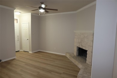 Unfurnished living room featuring ceiling fan, wo