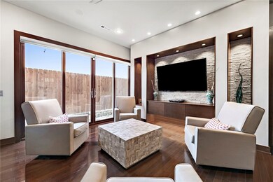 Additional living area downstairs with built-ins and sliding doors to an outdoor patio.