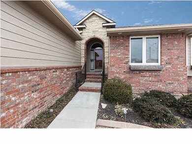 Covered entrance and attractive landscaping