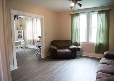 Living Room boasts high ceilings, fresh paint and 