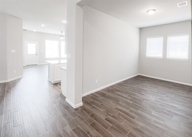 This house features a breezy open floor plan that flows easily and maximize space - Here is a view of the large study/home office, the kitchen and family room