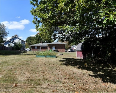 View of yard featuring a vegetable garden and an outdoor structure