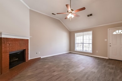 Unfurnished living room with lofted ceiling, ceiling fan, ornamental molding, dark hardwood / wood-style floors, and a fireplace
