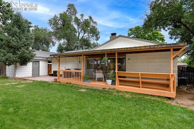 Back Of Home With Covered Deck And Patio